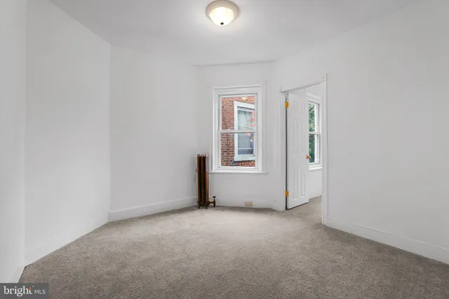 an empty room with windows and entrance