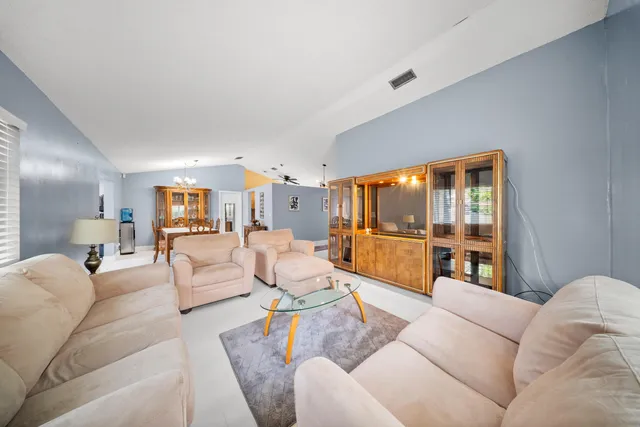 a spacious bedroom with a bed and a flat screen tv