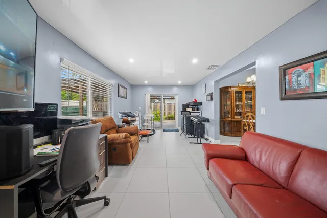 a kitchen with stainless steel appliances granite countertop a sink a stove and a refrigerator