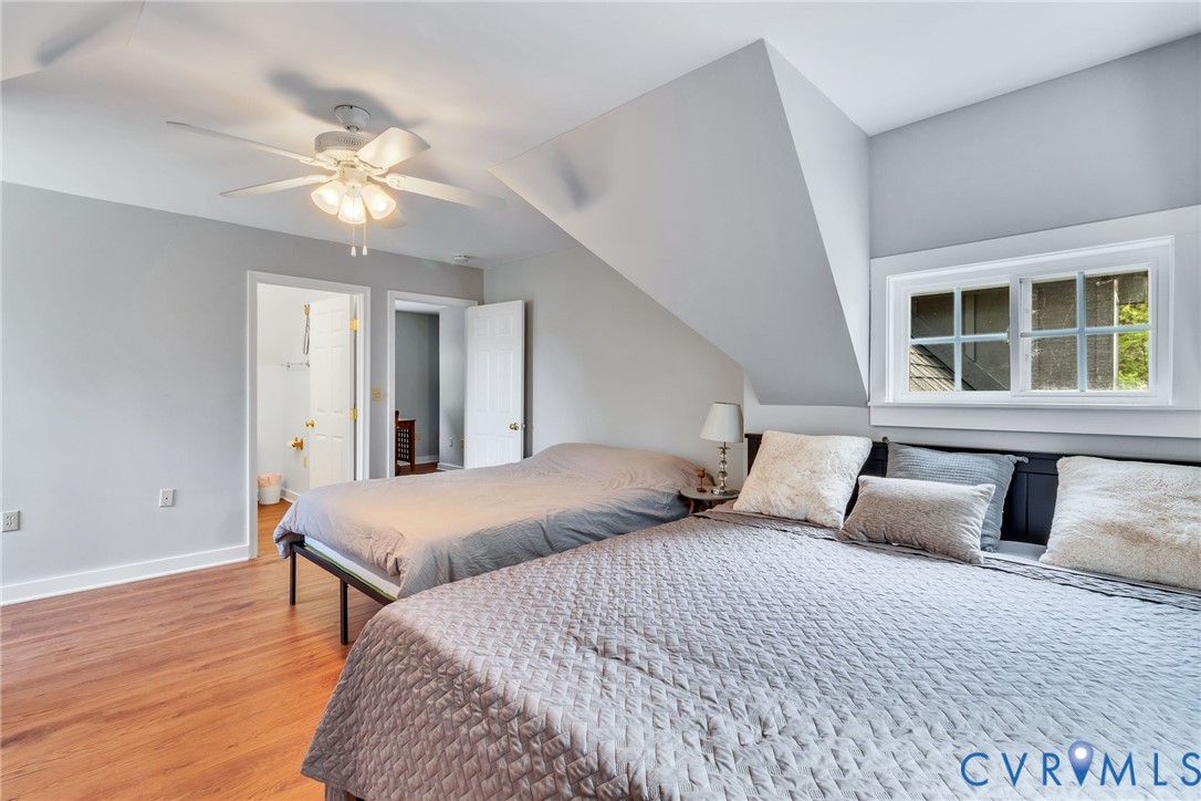 193 Deep Water Lane Reedville, VA 22539 - Photo 28 of 84 a bedroom with a large bed and a chandelier