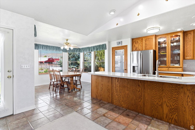 72 Canal Bank Road Garland, UT 84312 - Photo 11 of 40 Bright kitchen and dining area featuring natural wood cabinetry, stainless steel refrigerator, white countertops, and tiled flooring