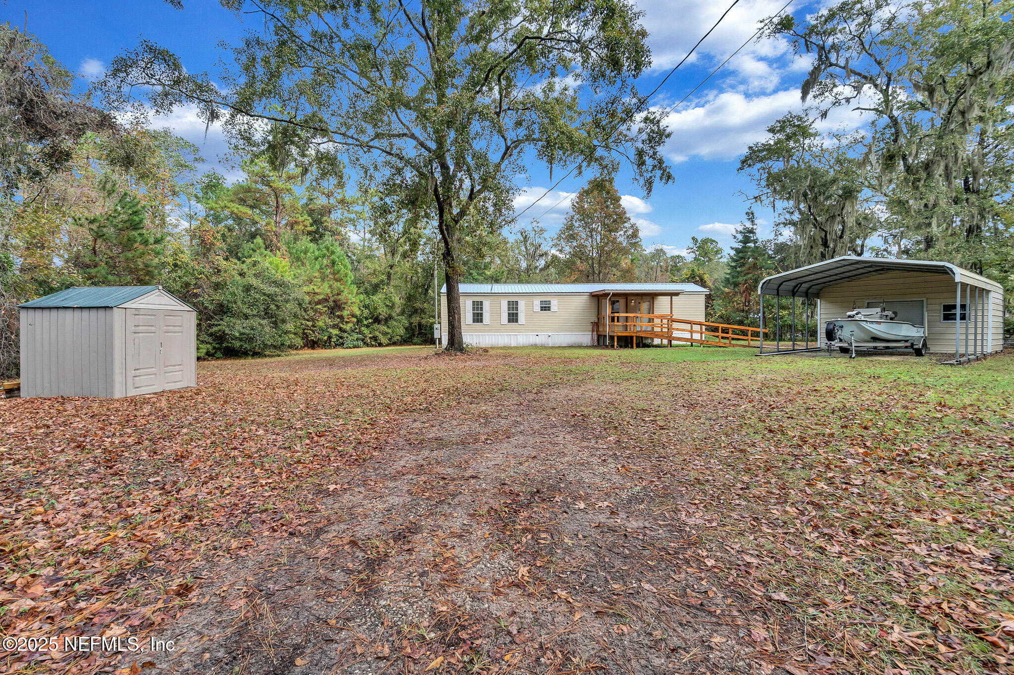 86446 Peeples Road Yulee, FL 32097 - Photo 1 of 42 front view of a house with a yard and large trees