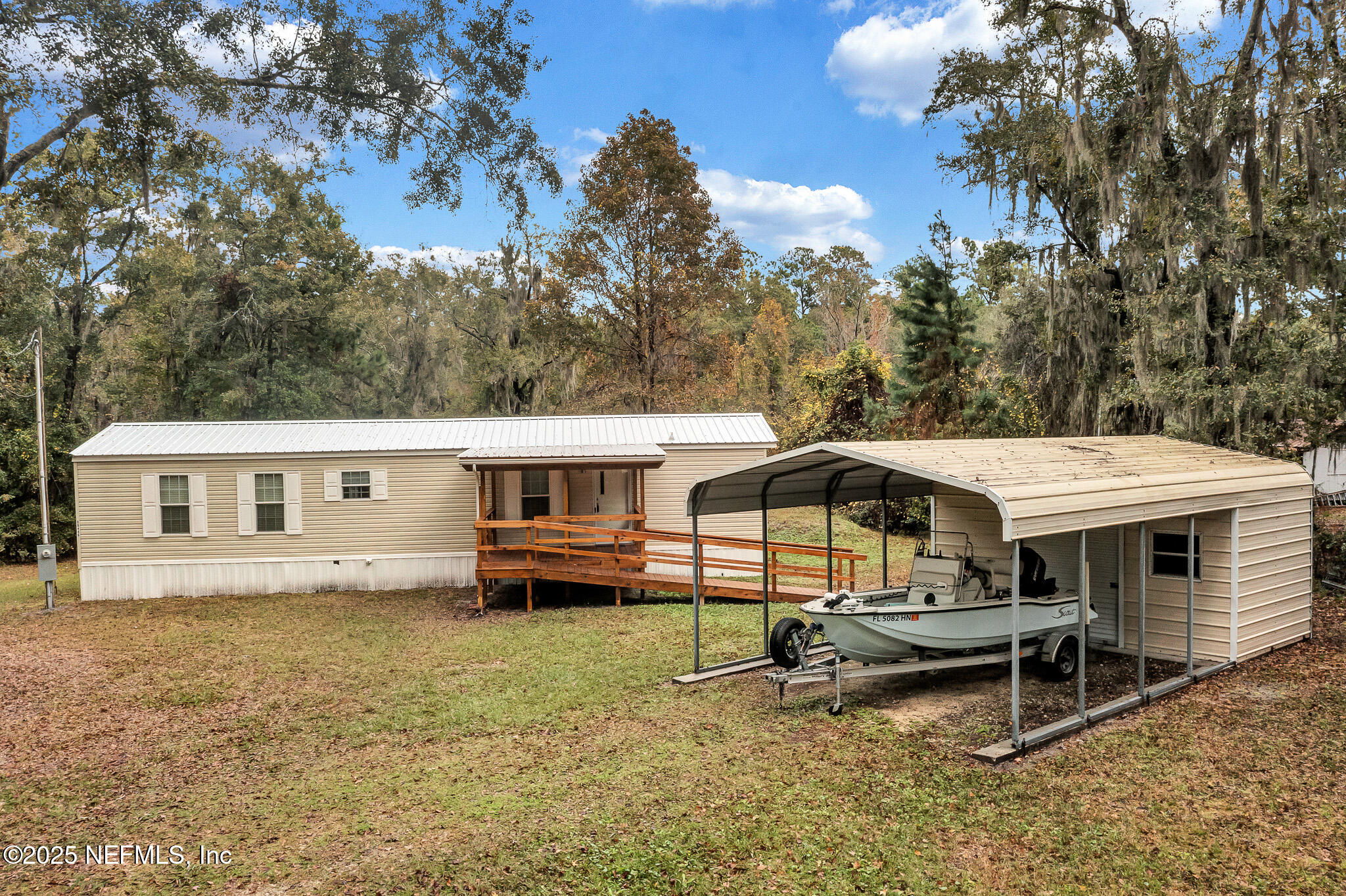86446 Peeples Road Yulee, FL 32097 - Photo 11 of 42 a backyard of a house with barbeque oven fire pit table and chairs