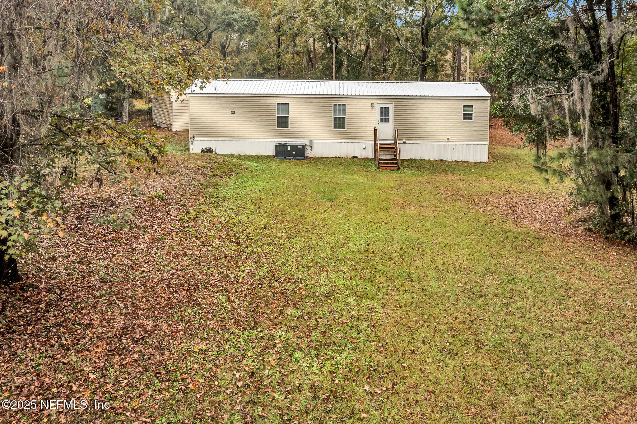 86446 Peeples Road Yulee, FL 32097 - Photo 15 of 42 a view of a couches in front of house with trees
