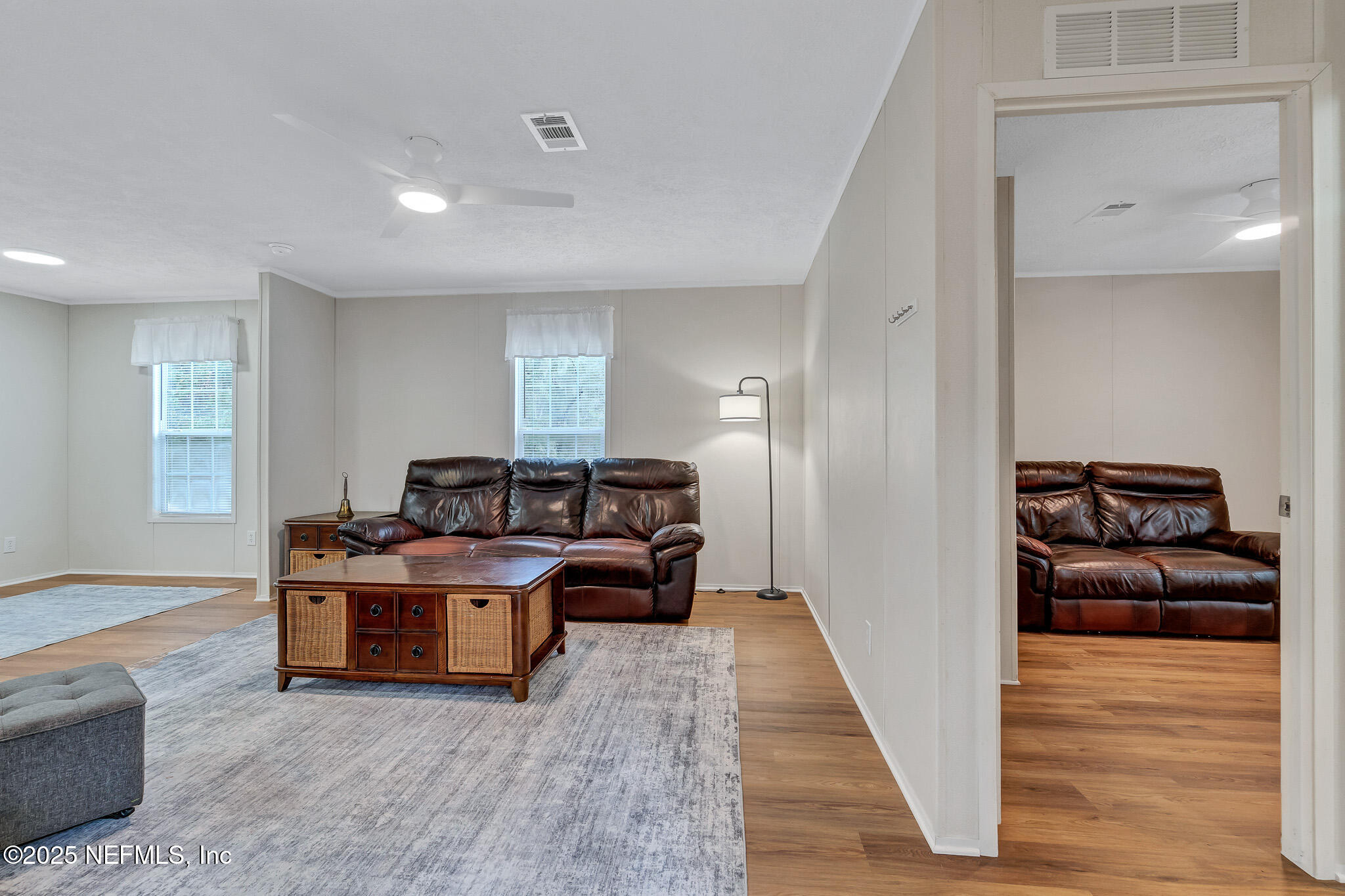 86446 Peeples Road Yulee, FL 32097 - Photo 22 of 42 a living room with furniture and a wooden floor