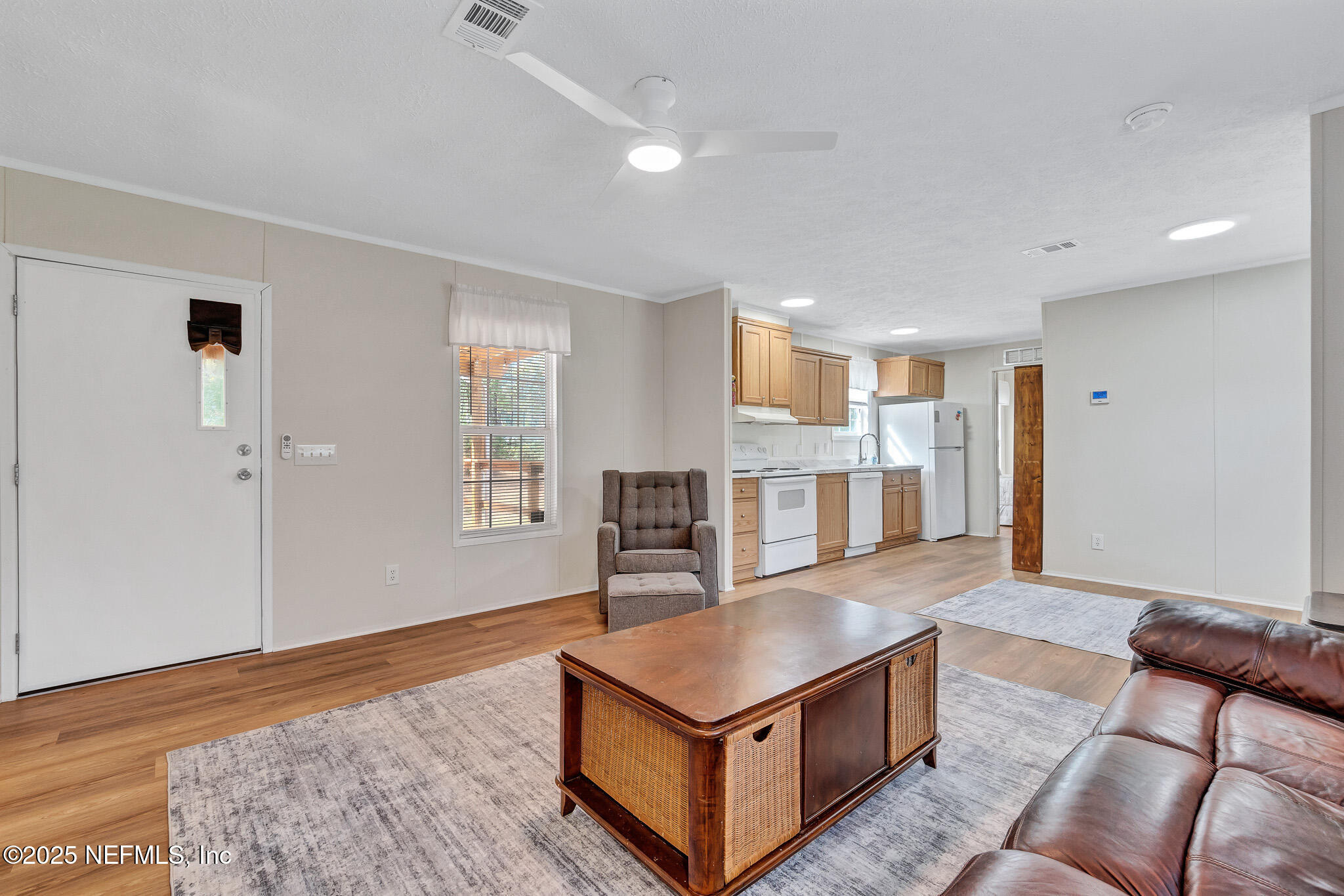 86446 Peeples Road Yulee, FL 32097 - Photo 24 of 42 a living room with stainless steel appliances kitchen island hardwood floor and a window