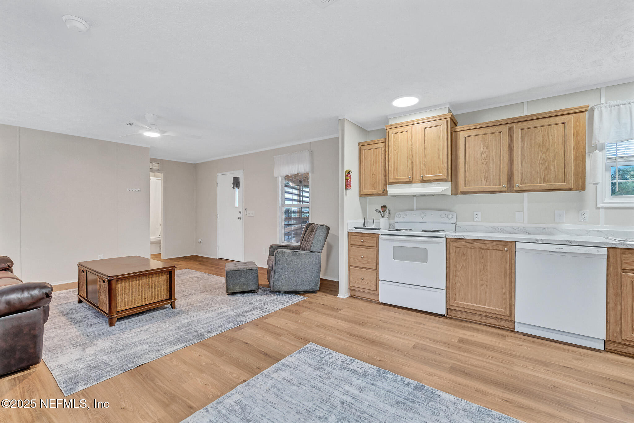 86446 Peeples Road Yulee, FL 32097 - Photo 27 of 42 a kitchen with stainless steel appliances granite countertop a stove a sink and a refrigerator