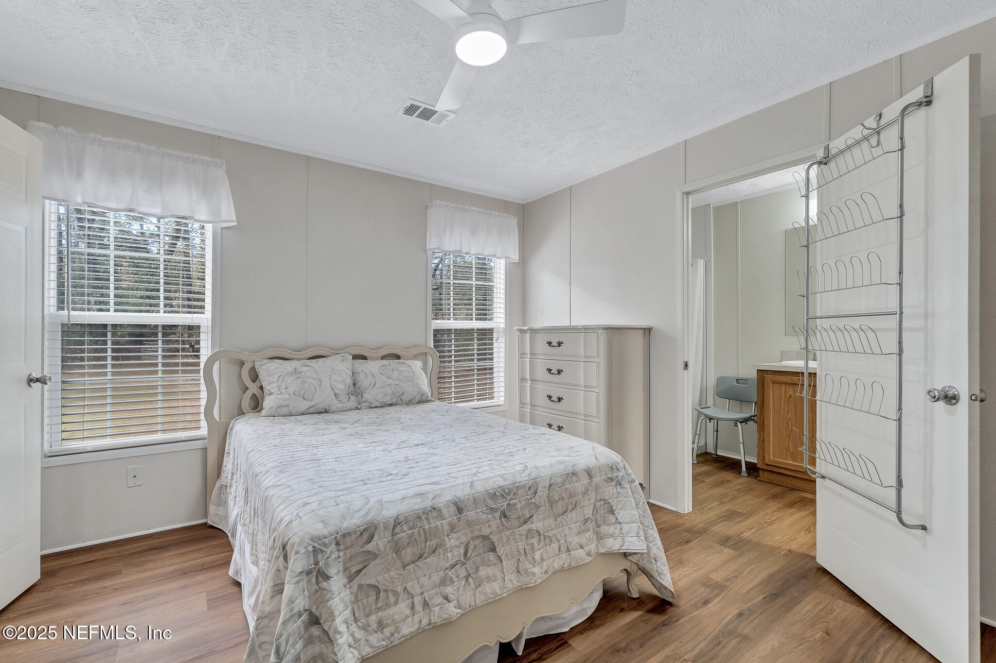 86446 Peeples Road Yulee, FL 32097 - Photo 30 of 42 a bedroom with a bed and a view of bathroom