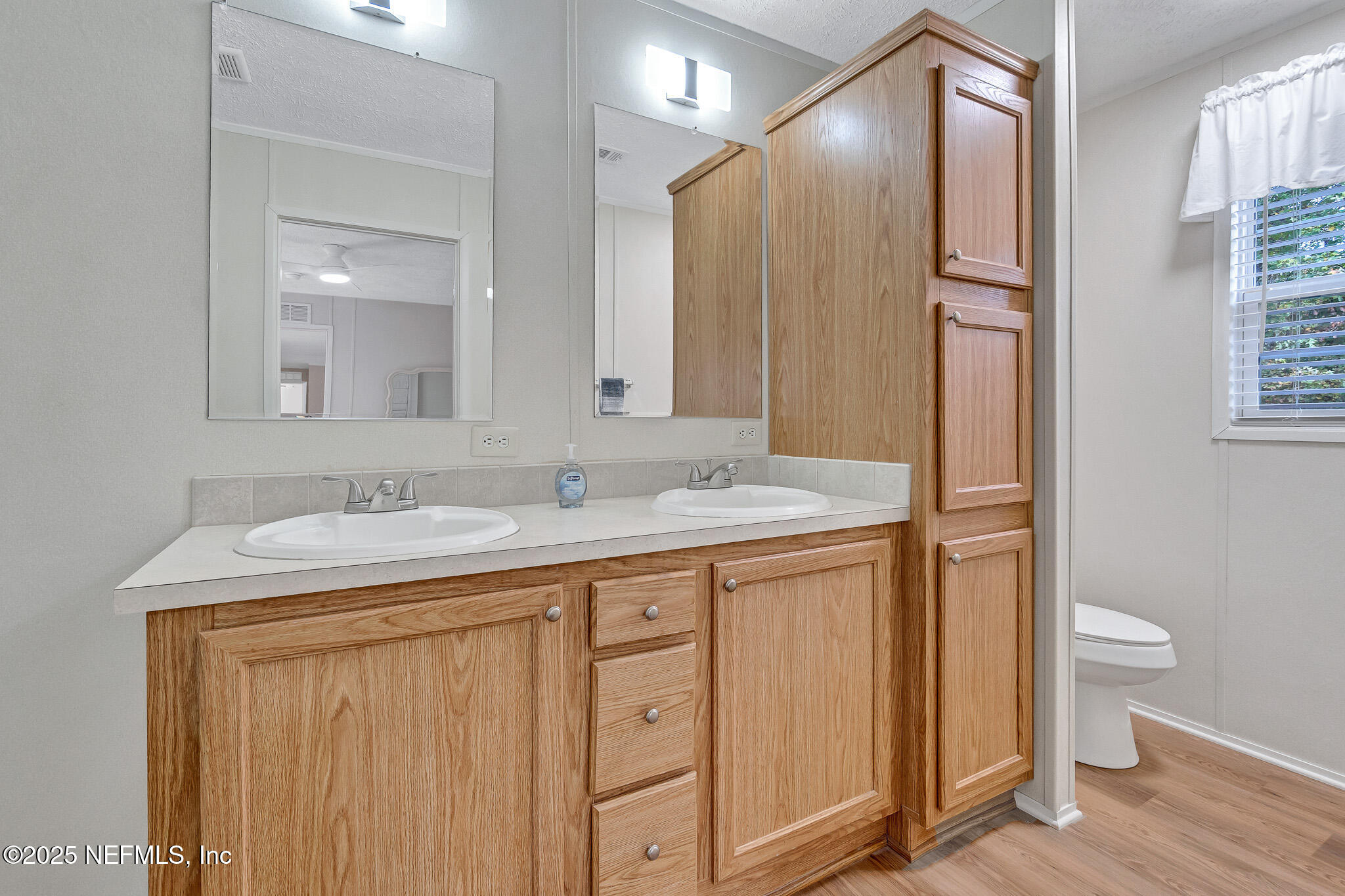 86446 Peeples Road Yulee, FL 32097 - Photo 33 of 42 a bathroom with 2 sink and a mirror