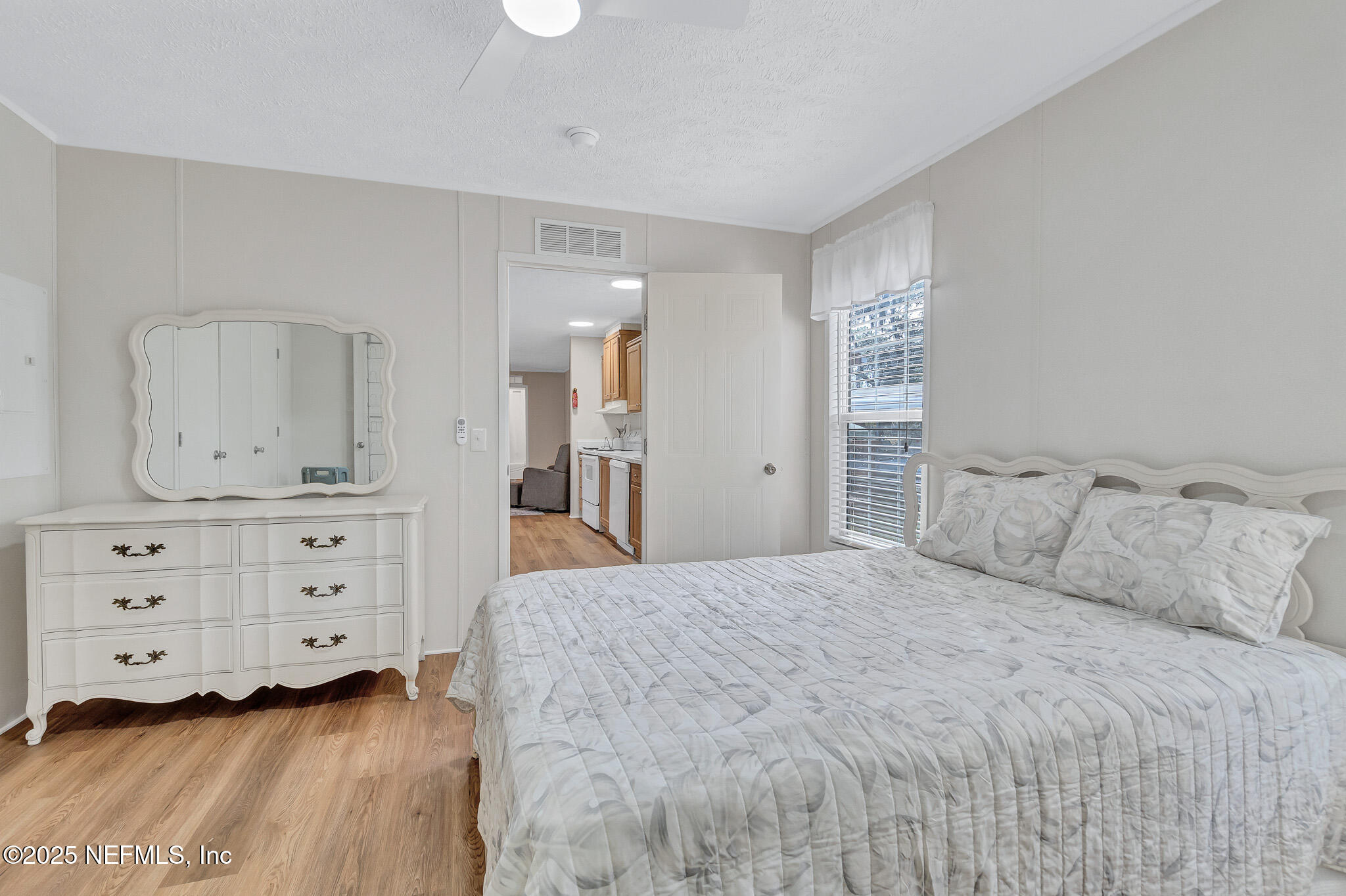 86446 Peeples Road Yulee, FL 32097 - Photo 35 of 42 a bedroom with a bed and a dresser