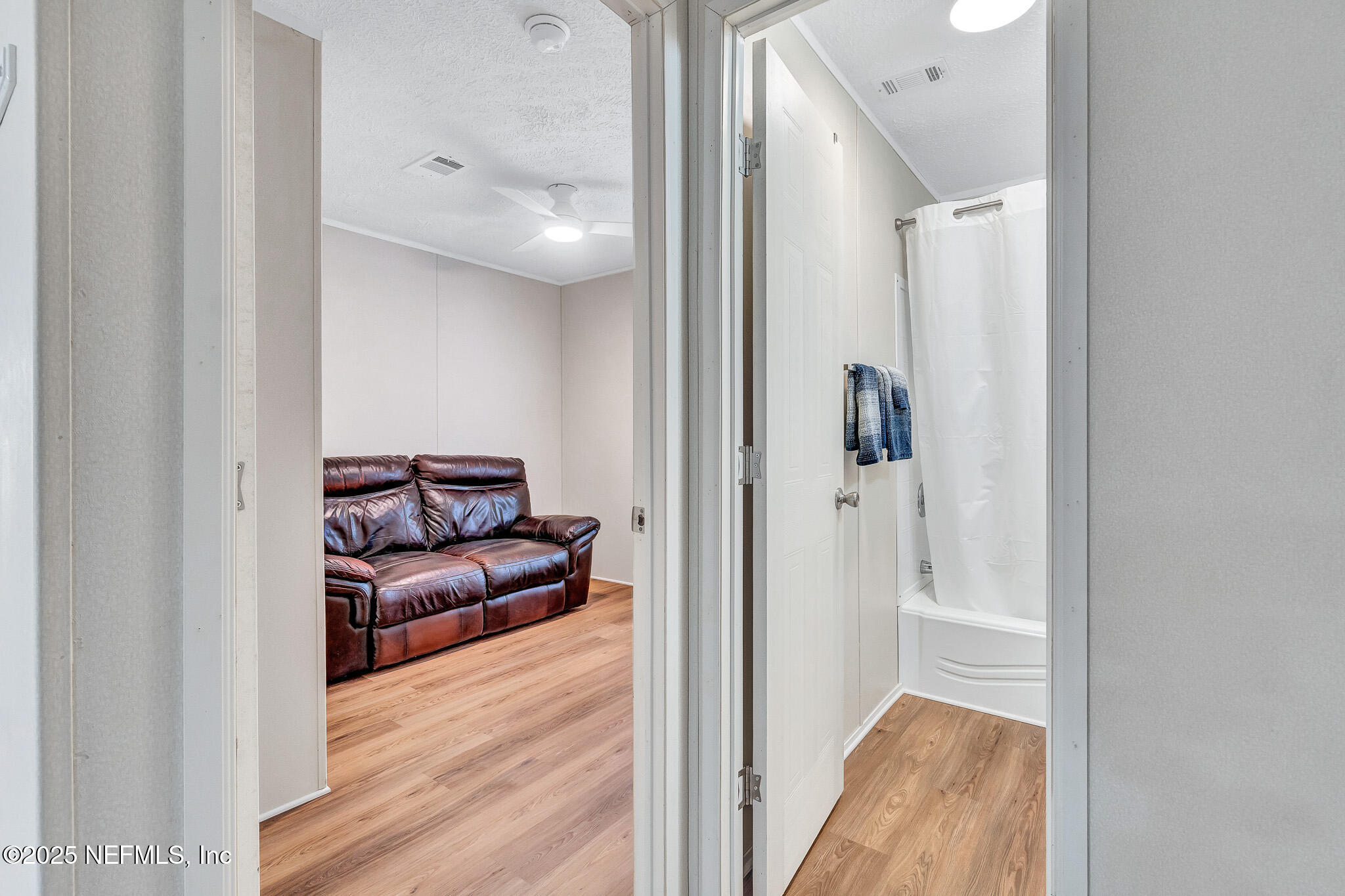 86446 Peeples Road Yulee, FL 32097 - Photo 41 of 42 a view of a hallway with wooden floor and furniture