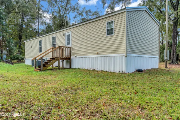 a view of a house with a backyard