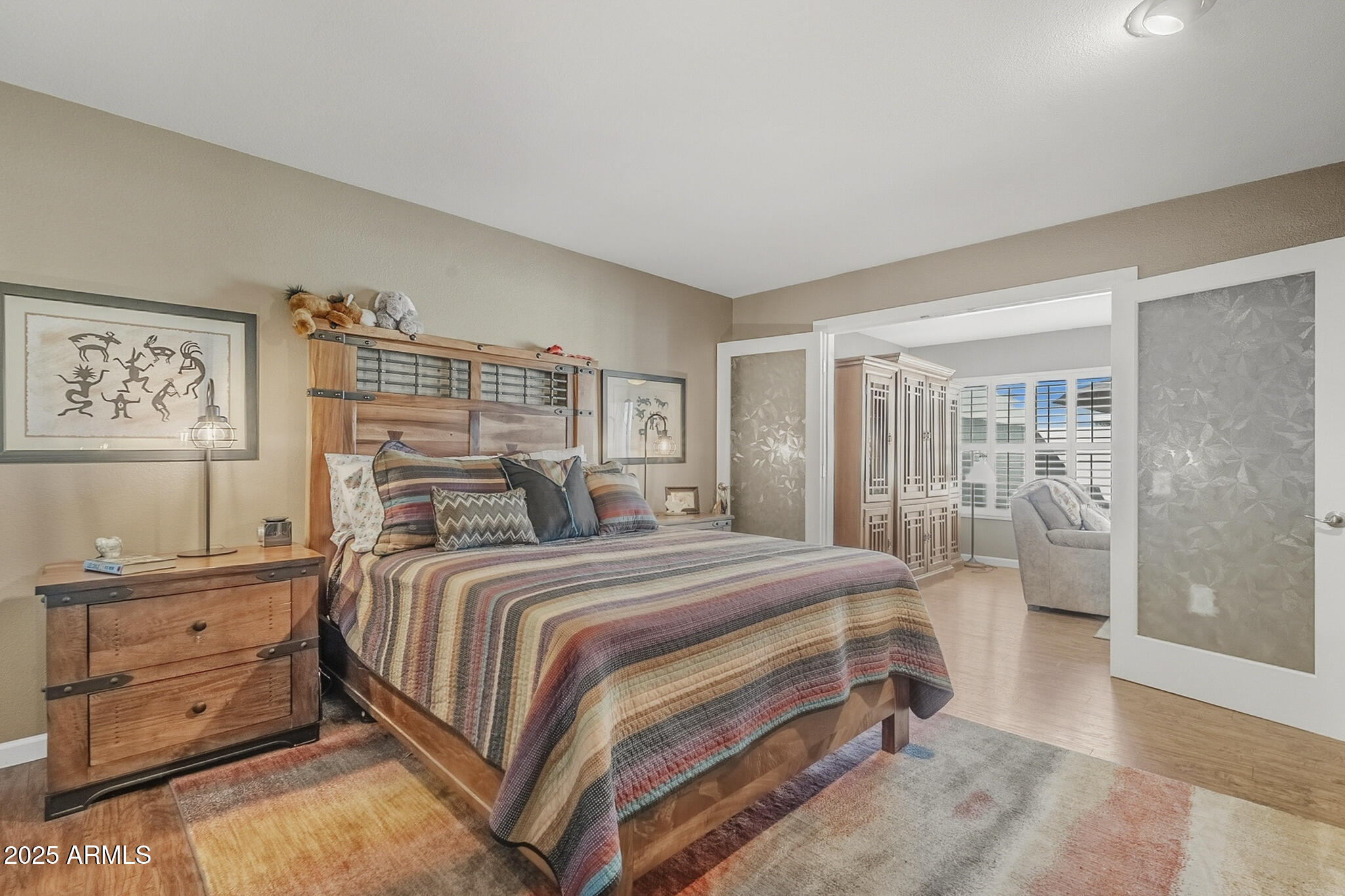 10010 West Royal Oak Road, Unit R Sun City, AZ 85351 - Photo 14 of 28 a bedroom with a large bed and a window