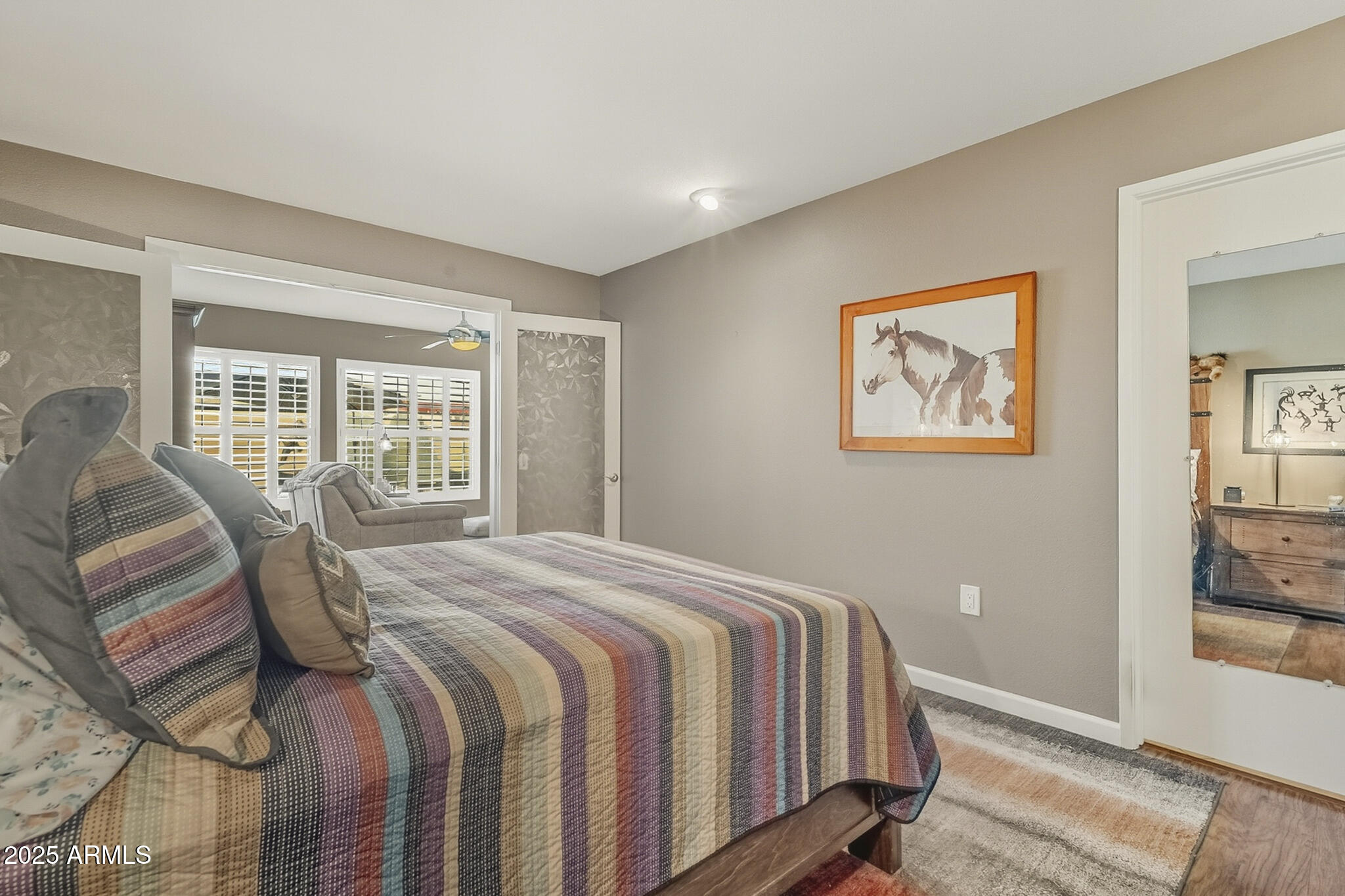 10010 West Royal Oak Road, Unit R Sun City, AZ 85351 - Photo 15 of 28 a bedroom with a large bed and a window