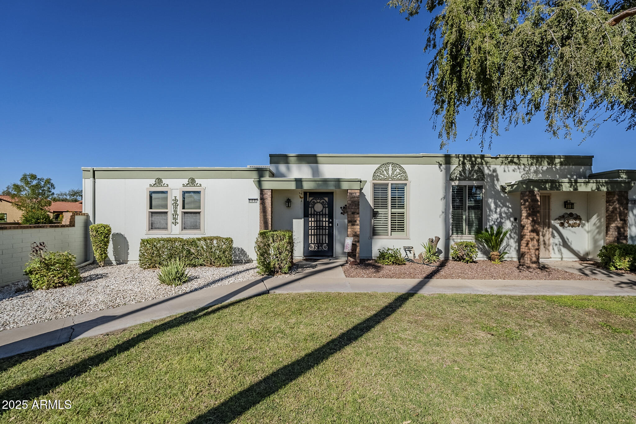 10010 West Royal Oak Road, Unit R Sun City, AZ 85351 - Photo 25 of 28 a view of a house with backyard porch and sitting area