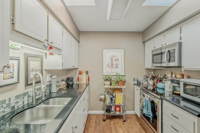 a kitchen with sink cabinets and window