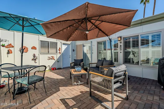 a patio with a patio table and chairs