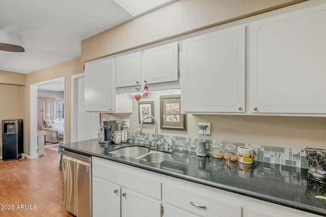 a kitchen with sink and cabinets