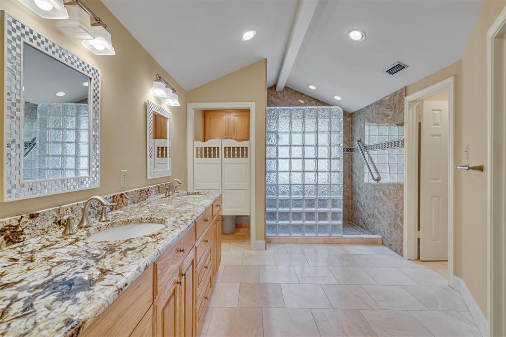 7019 Spring Valley Road Dallas, TX 75254 - Photo 12 of 19 a bathroom with a granite countertop sink a large mirror and shower