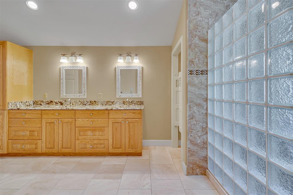 7019 Spring Valley Road Dallas, TX 75254 - Photo 13 of 19 a bathroom with a granite countertop sink and a mirror