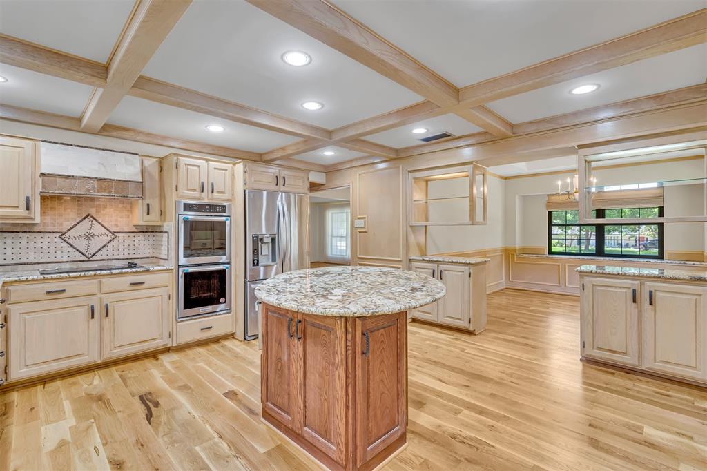 7019 Spring Valley Road Dallas, TX 75254 - Photo 2 of 19 a room with stainless steel appliances kitchen island granite countertop a stove and cabinets