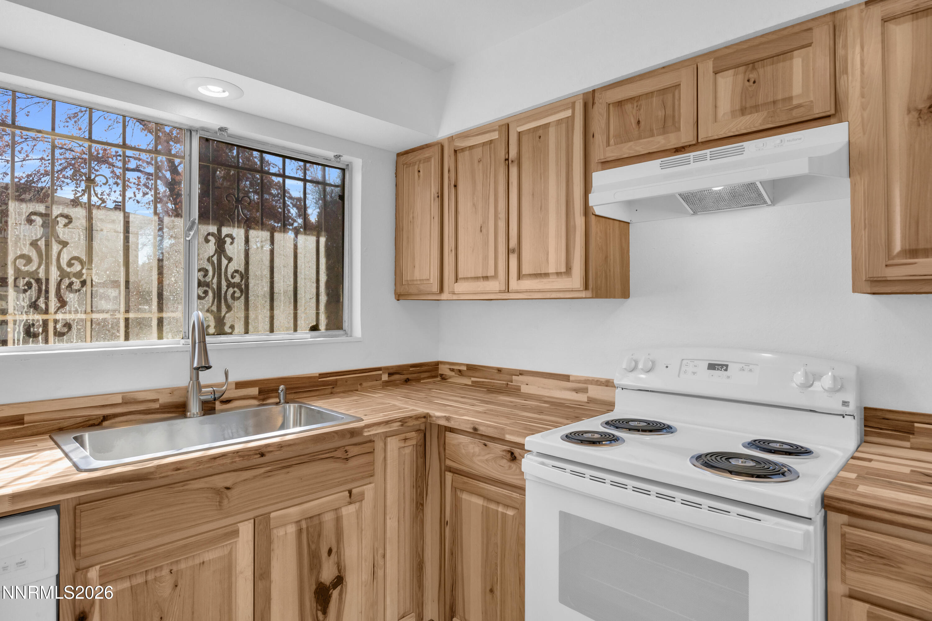 577 Smithridge Park Reno, NV 89502 - Photo 13 of 31 a view of a kitchen with a sink a stove and a refrigerator
