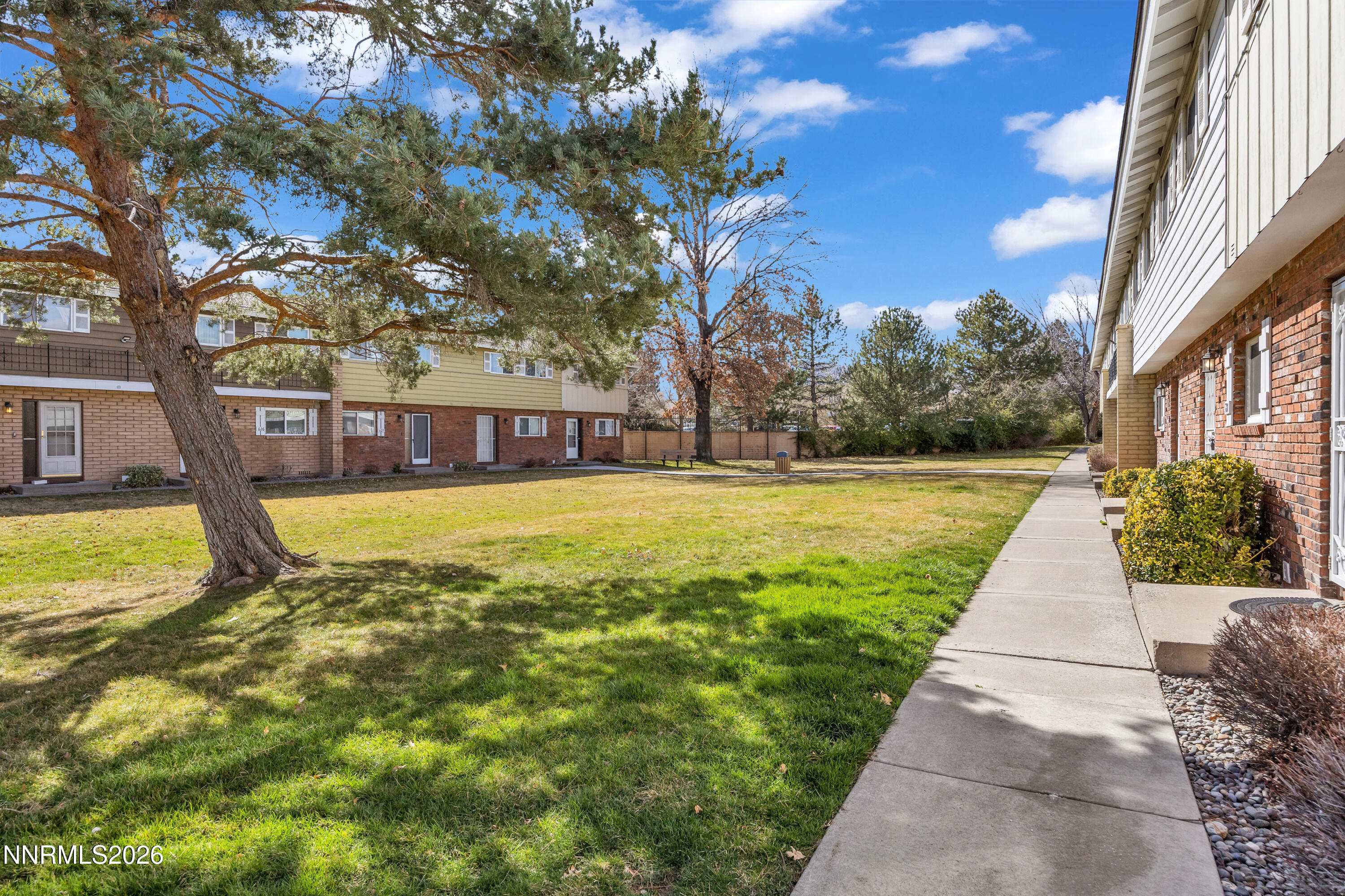 577 Smithridge Park Reno, NV 89502 - Photo 7 of 31 a view of swimming pool with lawn chairs and large trees