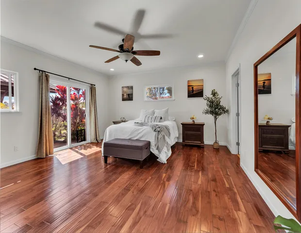 a bedroom with furniture and a wooden floor