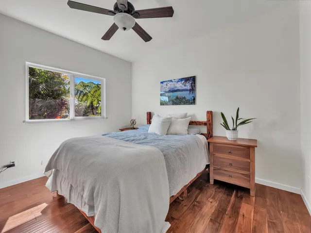 a bedroom with a bed and a painting on the wall