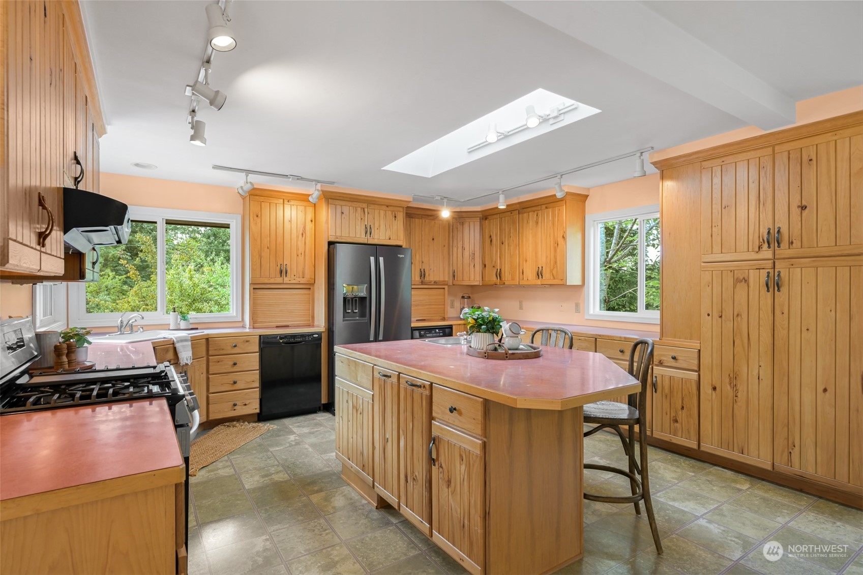 6366 Mission Road Everson, WA 98247 - Photo 15 of 40 a kitchen with refrigerator cabinets and wooden floor