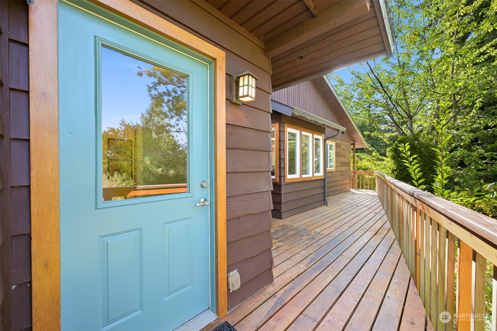 6366 Mission Road Everson, WA 98247 - Photo 39 of 40 a view of a balcony with wooden floor and fence and a floor to ceiling window