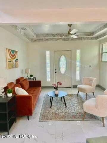 a living room with couches and kitchen view