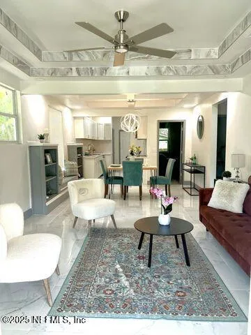 a living room with furniture and a chandelier