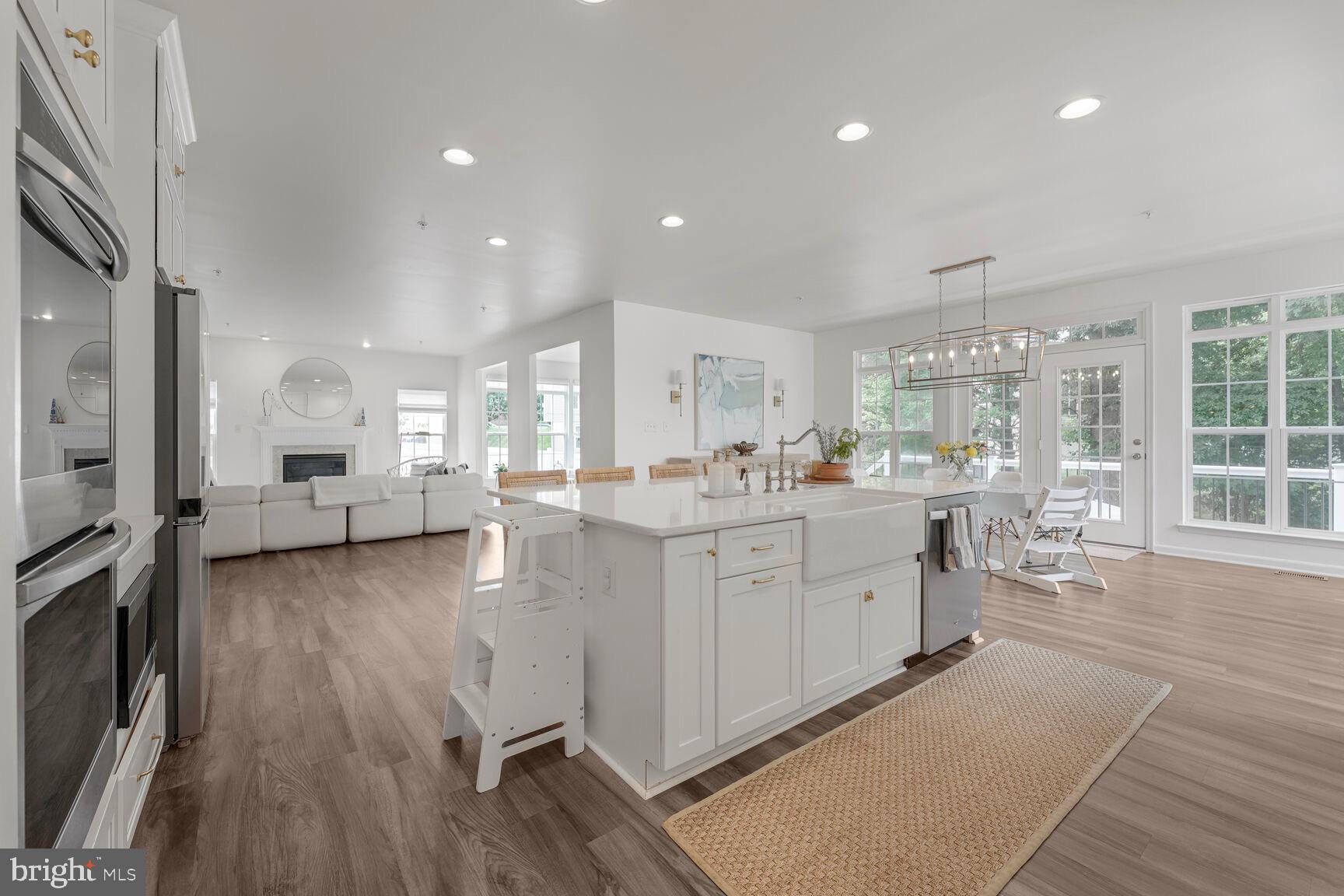 2604 Tree View Way Fort Washington, MD 20744 - Photo 11 of 50 a large white kitchen with lots of counter space wooden floor and appliances