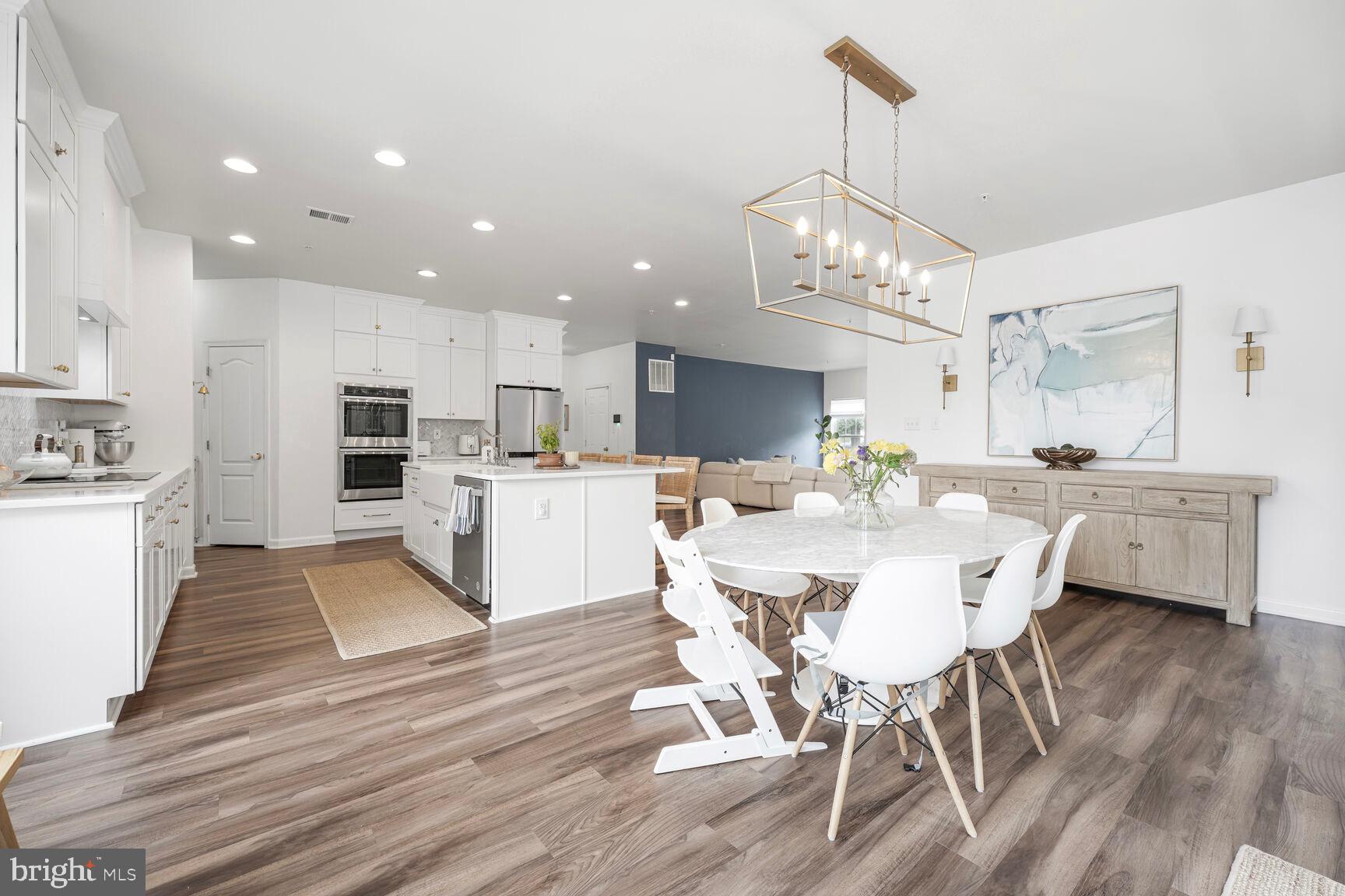 2604 Tree View Way Fort Washington, MD 20744 - Photo 15 of 50 a view of a dining room and livingroom with furniture wooden floor a chandelier