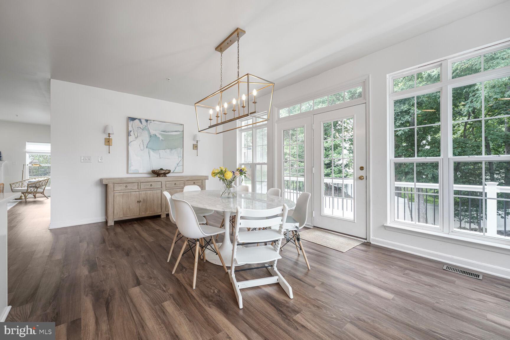 2604 Tree View Way Fort Washington, MD 20744 - Photo 16 of 50 a dining room with furniture a chandelier and wooden floor