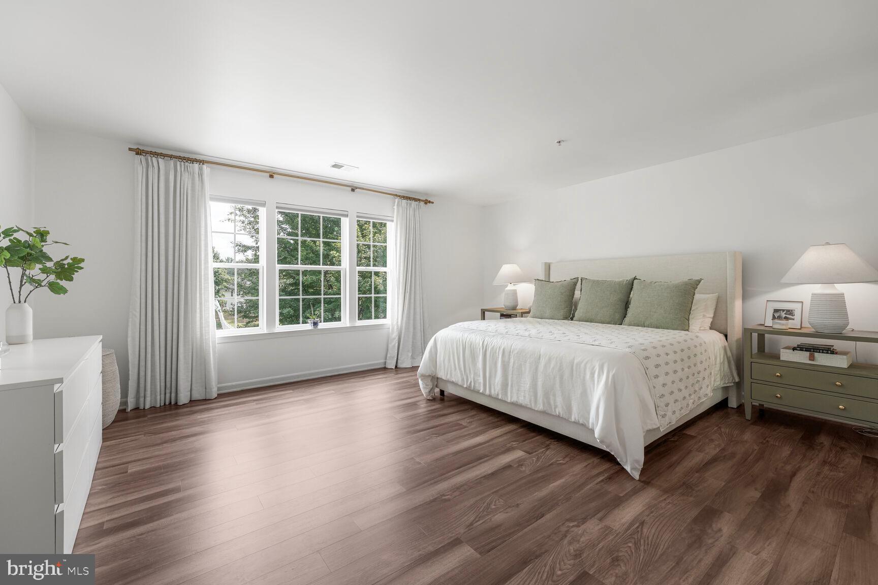 2604 Tree View Way Fort Washington, MD 20744 - Photo 24 of 50 a bedroom with a large bed and a large window