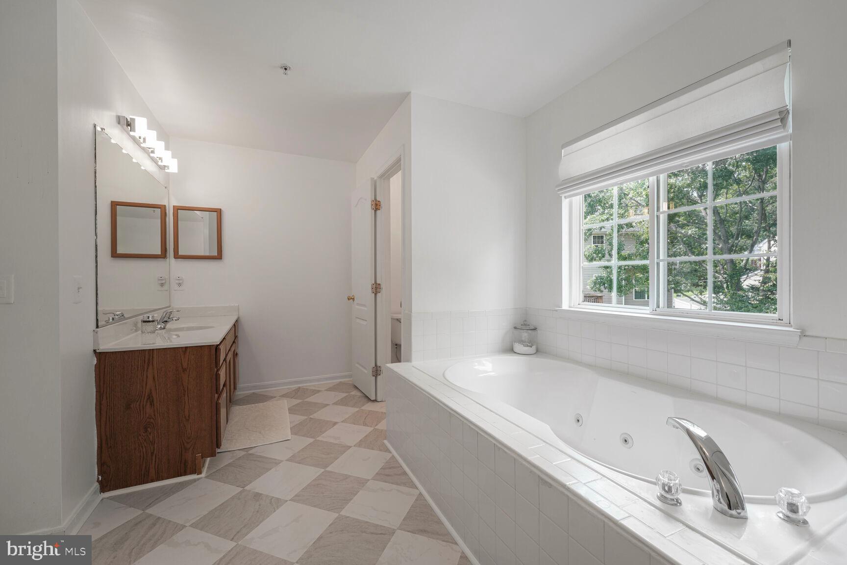 2604 Tree View Way Fort Washington, MD 20744 - Photo 27 of 50 a spacious bathroom with a tub sink and mirror