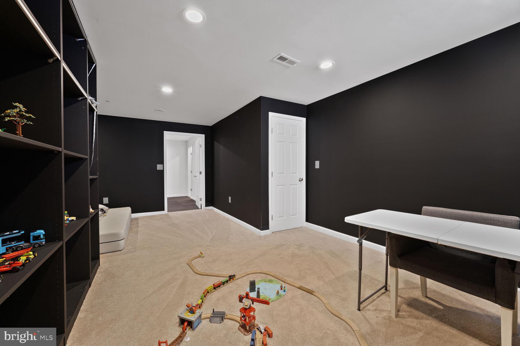 2604 Tree View Way Fort Washington, MD 20744 - Photo 39 of 50 a bedroom with a bed and a table in it