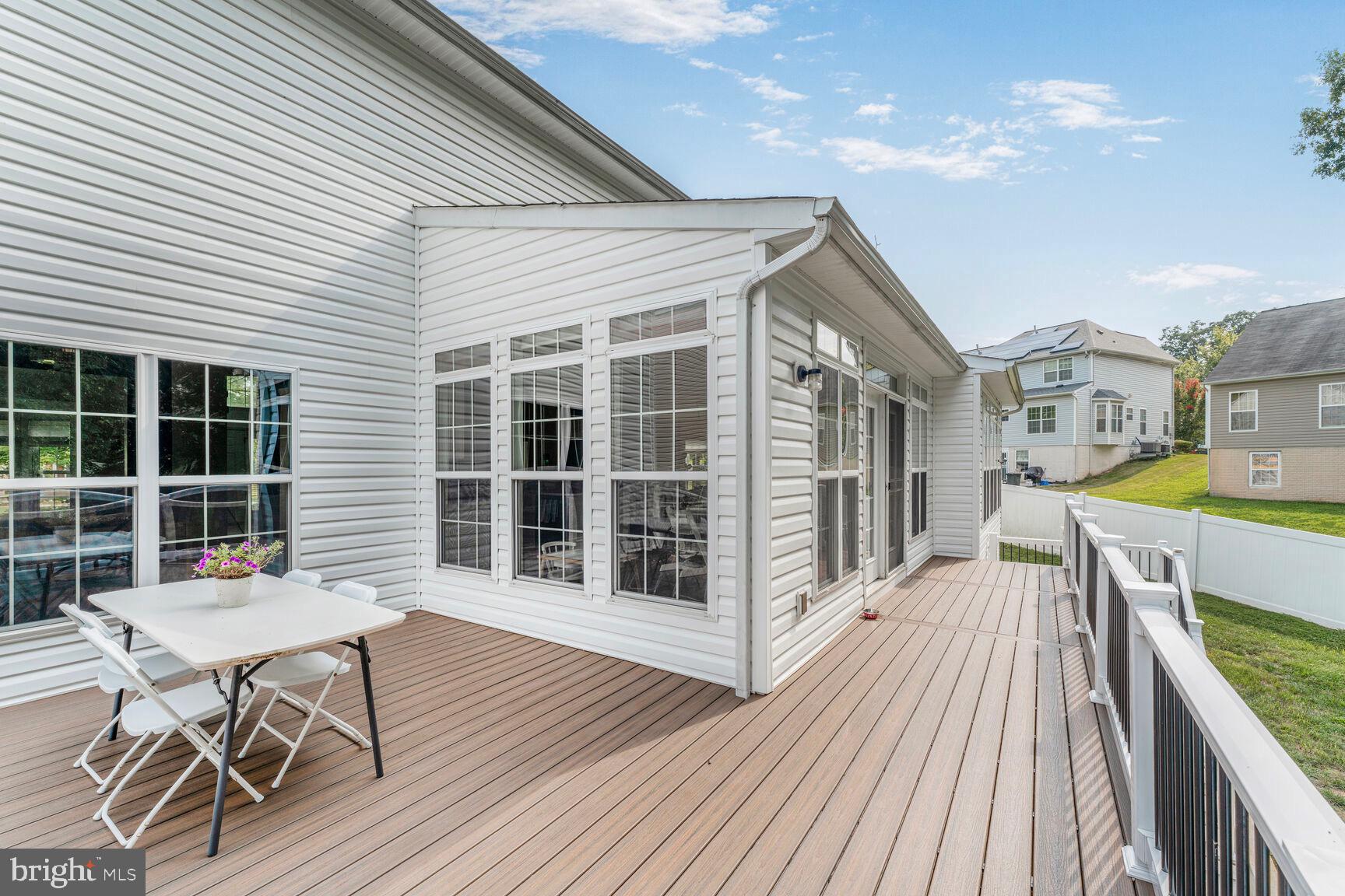2604 Tree View Way Fort Washington, MD 20744 - Photo 45 of 50 a balcony with wooden floor table and chairs