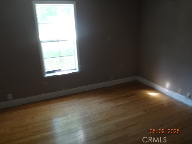 17312 Cache Creek Road Clearlake Oaks, CA 95423 - Photo 15 of 20 a view of an empty room with wooden floor and a window