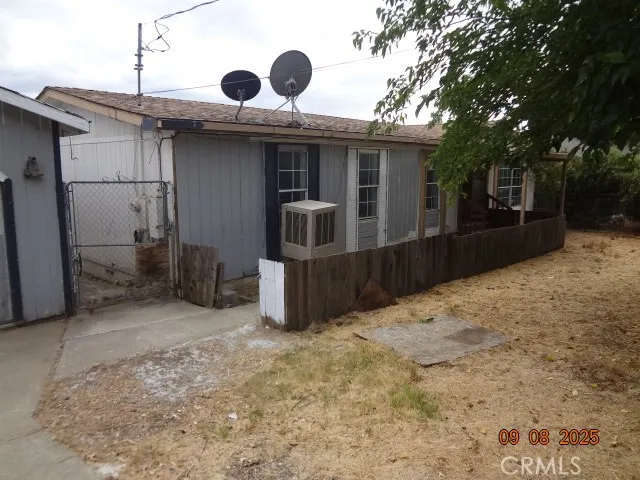 a view of a house with a wooden fence