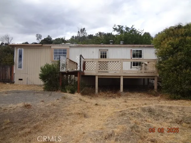 aerial view of a house with yard and lake view