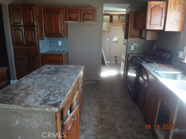 17312 Cache Creek Road Clearlake Oaks, CA 95423 - Photo 9 of 20 a kitchen with granite countertop a stove a sink and a refrigerator