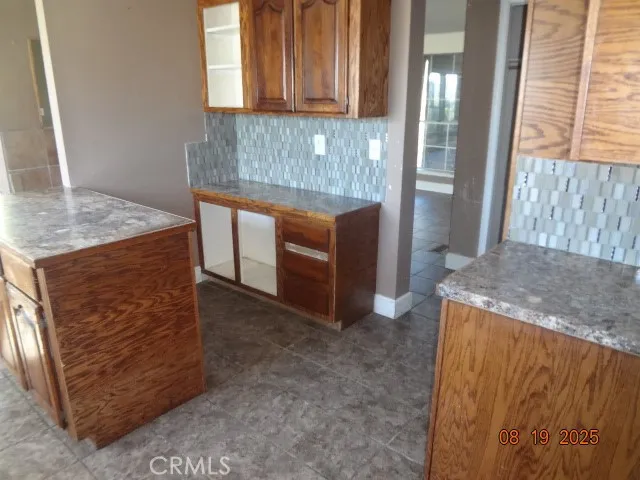 a kitchen with stainless steel appliances granite countertop wooden cabinets and a granite counter tops