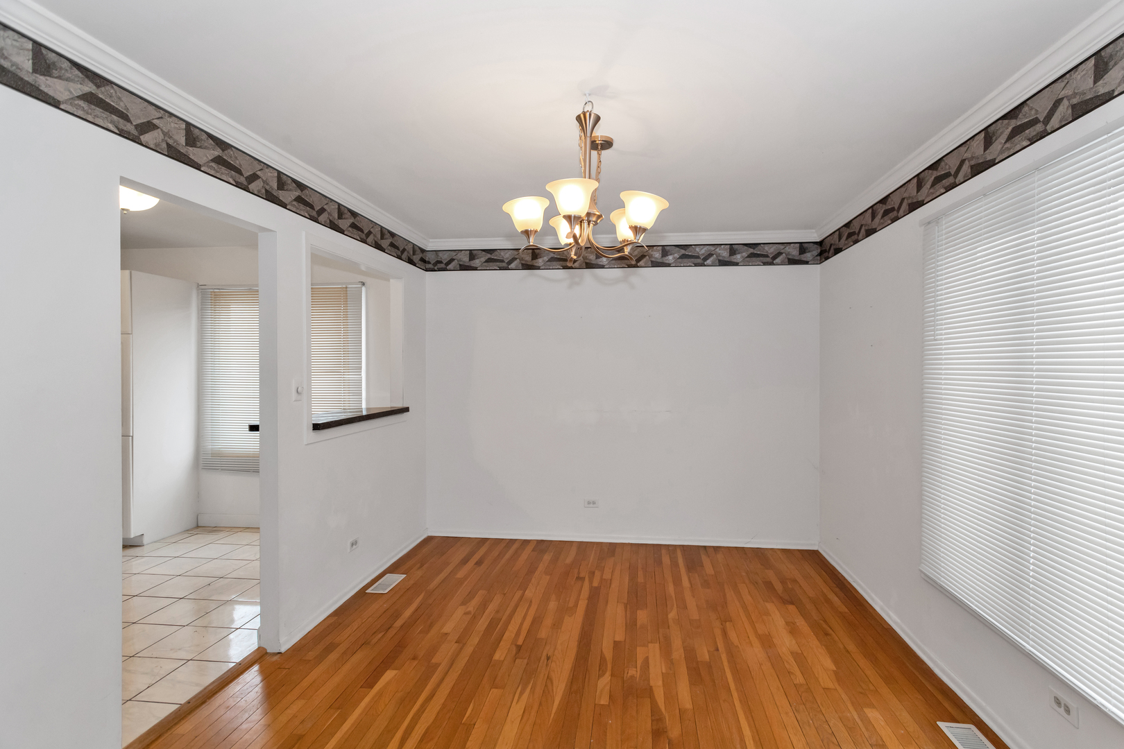1900 Chippendale Road Hoffman Estates, IL 60169 - Photo 13 of 37 a view of a room with wooden floor chandelier and a window