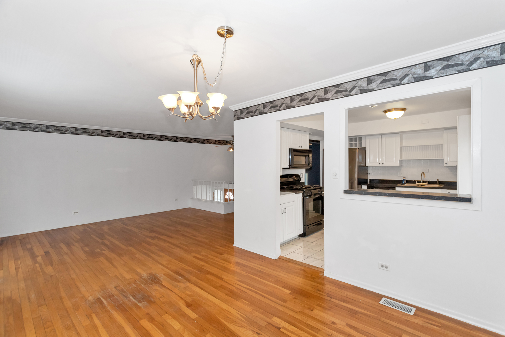 1900 Chippendale Road Hoffman Estates, IL 60169 - Photo 14 of 37 a view of a hallway with wooden floor and a kitchen