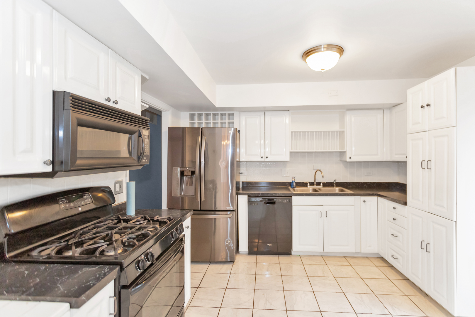 1900 Chippendale Road Hoffman Estates, IL 60169 - Photo 15 of 37 a kitchen with stainless steel appliances granite countertop a stove top oven a sink dishwasher and a refrigerator with wooden cabinets