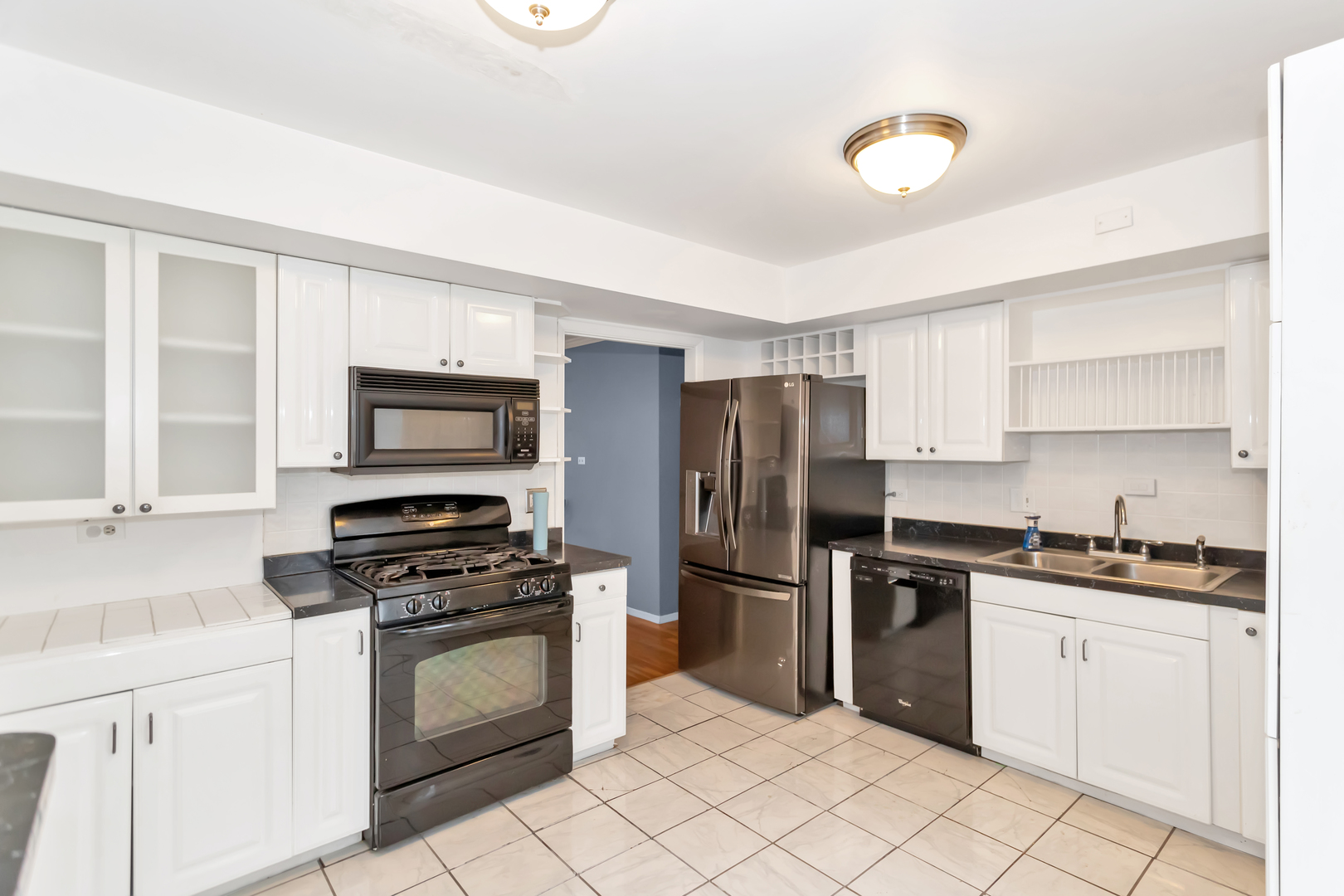1900 Chippendale Road Hoffman Estates, IL 60169 - Photo 16 of 37 a kitchen with white cabinets and stainless steel appliances