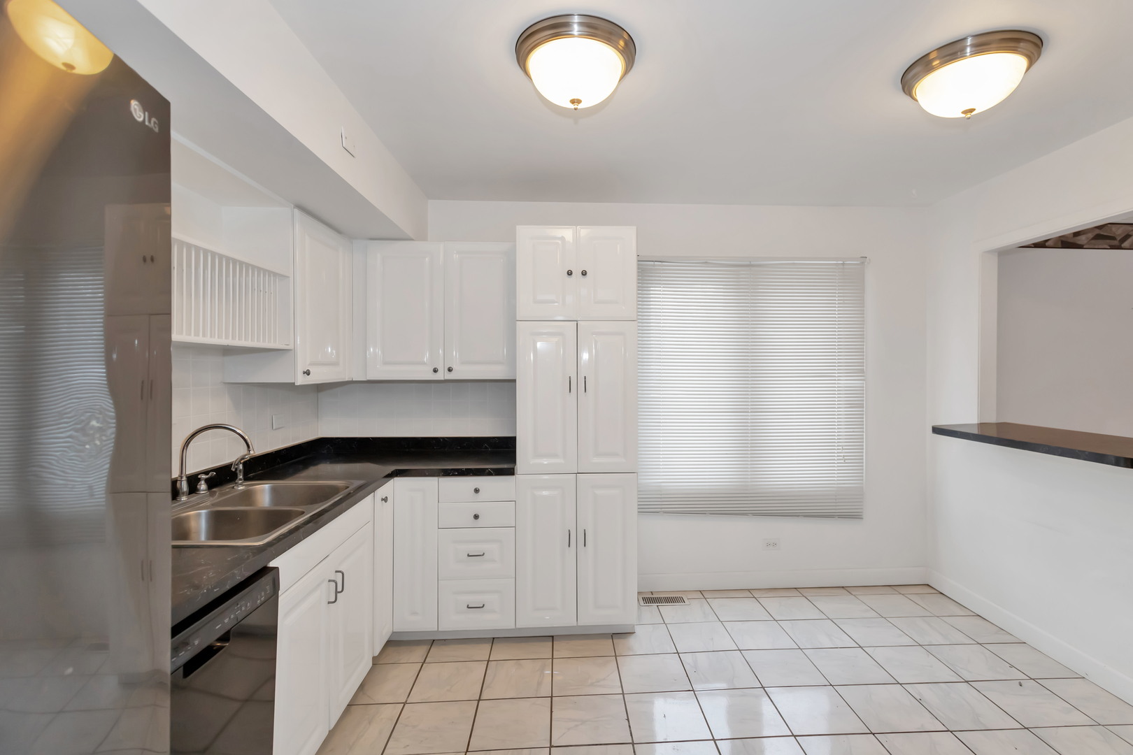 1900 Chippendale Road Hoffman Estates, IL 60169 - Photo 17 of 37 a kitchen with granite countertop a sink a stove a refrigerator and cabinets